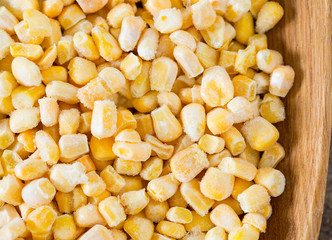 frozen sweet corn on woode surface