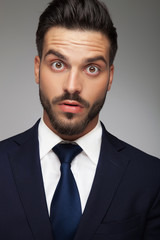 businessman making big eyes because he is amazed and shocked