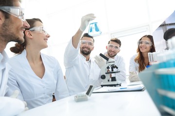 Fototapeta premium group of young workers are working in biochemistry lab,