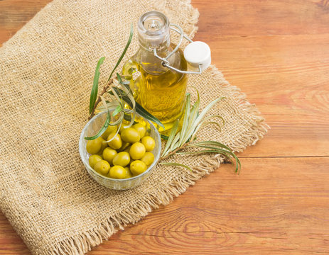 Green olives, olive oil and olive branches