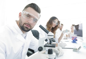 close-up of a scientific researcher with microscope