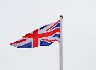 developing the flag of England against a gray sky