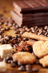 Aroma coffee chocolate cookies and spices on the wooden table. Dark wooden background. Top view. Close. Closeup.