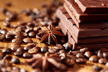 Aroma coffee chocolate cookies and spices on the wooden table. Dark wooden background. Top view. Close. Closeup.
