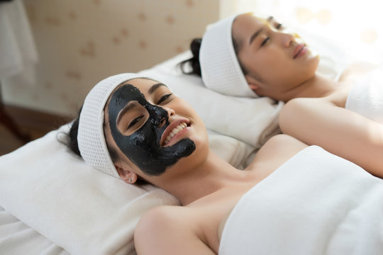 Beautiful woman getting facial mask at beauty salon.