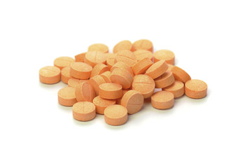 orange pills isolated on white background