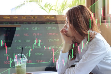 Side view of attractive young Asian business woman thinking and  looking through windows with candlestick chart patterns uptrend background. Stock market concept