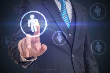 Businessman is touching screen with finger and selecting user in social network. Marketing concept.