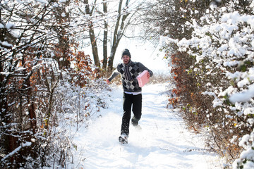 Happy man running with gift box