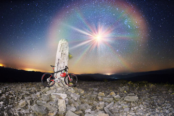 bike on a stone pillar tops at night