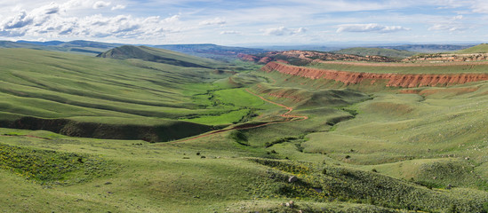 Green slopes lead down to Red Canyon in the wilderness of Wyoming.