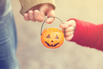 Little girl and her father, Halloween, parent and child trick or treating together. Toddler kid...