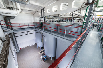 Large and tall steel cylindrical tanks for fermenting the yeast mixture.