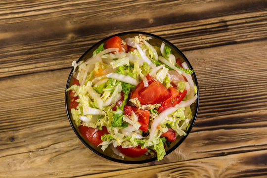 Fresh vegetable salad on wooden table