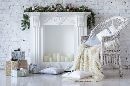 Christmas decorations near fireplace. White loft style
