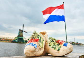 holland. Wooden shoes netherland flag and windmill in zaanse schans