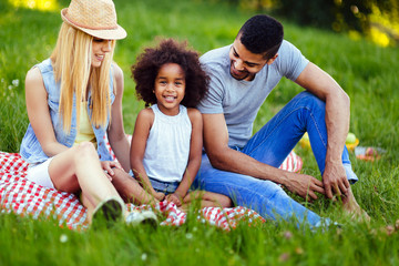 Picture of lovely couple with their daughter having picnic