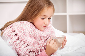 Flu. Sick little girl with hot lemon tea