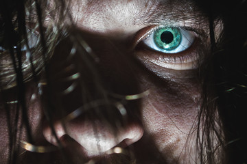 Portrait of a man with a green eye for horror or halloween.