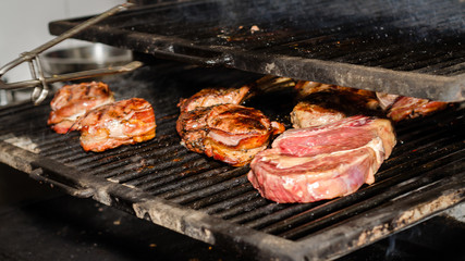 Meat and vegetables are roasted for guests on the grill