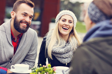 Happy adult couple dating in cafe