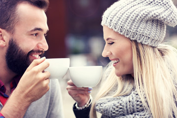Happy adult couple dating in cafe