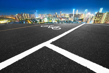 empty asphalt road and cityscape of Nanchang in blue sky at dawn