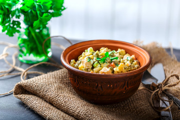 Russian salad in a bowl on the table