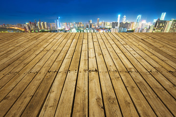 empty wooden floor with cityscape of hangzhou at twilight