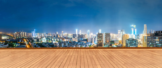 empty wooden floor with cityscape of hangzhou at twilight