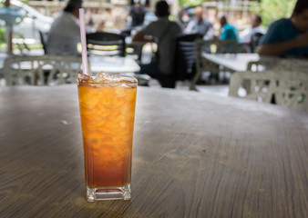 glass of ice tea on wooden table
