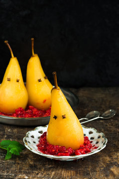 Poached pears on crushed raspberries, presented as ghosts