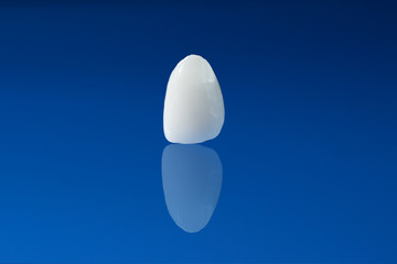 Ceramic crown on blue background