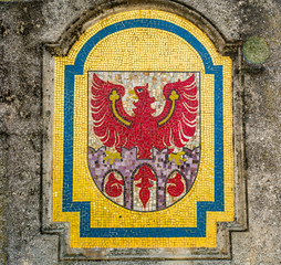 a mosaic that forms Merano's coat of arms: the red Tirolo's eagle on the three gates of the city.