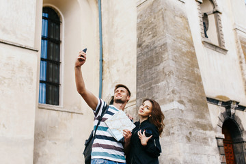 Man takes selfie with a pretty woman in old city