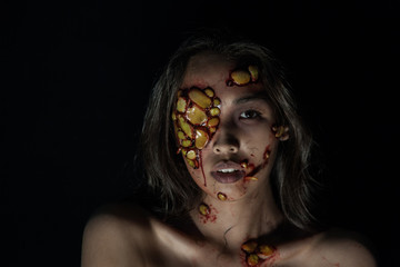 Girl with sores and blood on their face. realistic Halloween makeup.