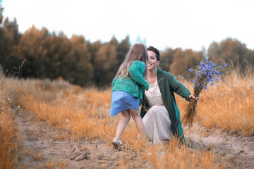 Mother with daughter walking on a road