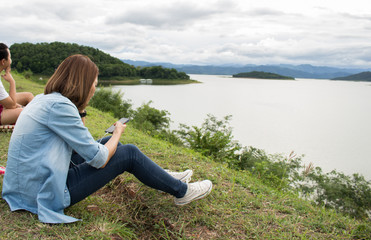 Woman playing mobile on him