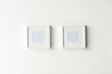 empty photo frames hanging on wall