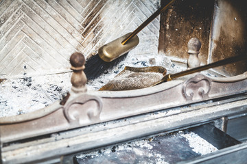 Cleaning fireplace with open tray.
