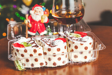 Christmas dessert. Cognac, Santa Claus and set of cakes