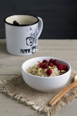 Breakfast with oatmeal and fresh raspberries.