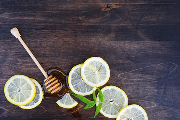 On a wooden texture background a lemon and honey