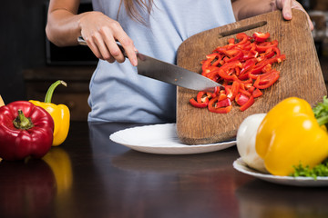 woman preparing pepper for dinner