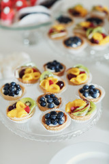 Baked baskets with fruits and berries on glass dish