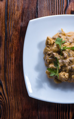 the remains of dinner with chicken and chanterelles with tomato creamy sauce and parsley