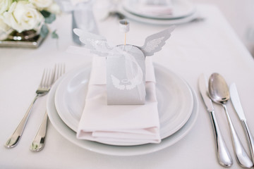 White paper box with wings stands on white dinner table