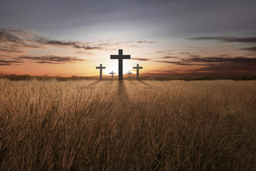 Bright christian cross at sunset