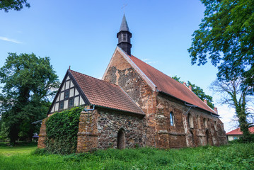 Fototapeta na wymiar Old bricks and stones gothic church from XIV century in small village Chlebowo, Poland