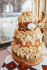 Layered wedding bread with flowers stands on steel dish